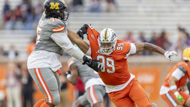 Feb 3, 2024; Mobile, AL, USA; American offensive lineman Javon Foster of Missouri (75) battle National edge Marshawn Kneeland of Western Michigan (99) during the second half of the 2024 Senior Bowl football game at Hancock Whitney Stadium. Mandatory Credit: Vasha Hunt-USA TODAY Sports  